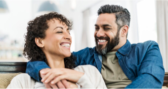 Smiling couple sitting on the couch