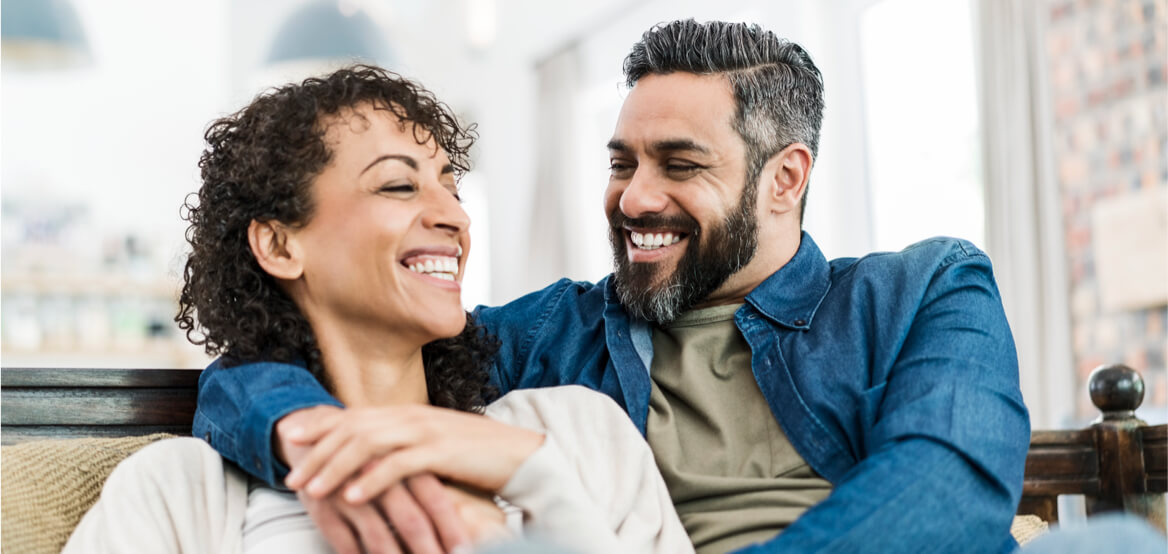 Smiling couple sitting on the couch