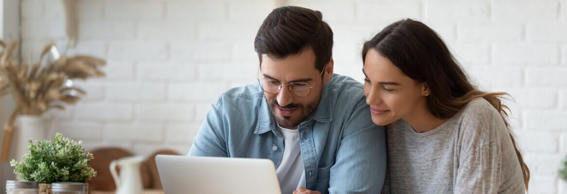 Couple using a laptop to research insurance