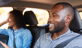 Man driving car with woman in passenger seat