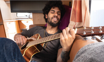 Man playing guitar in RV motorhome