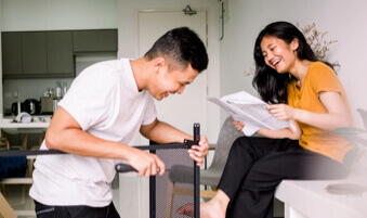 Smiling couple assembling furniture in living room