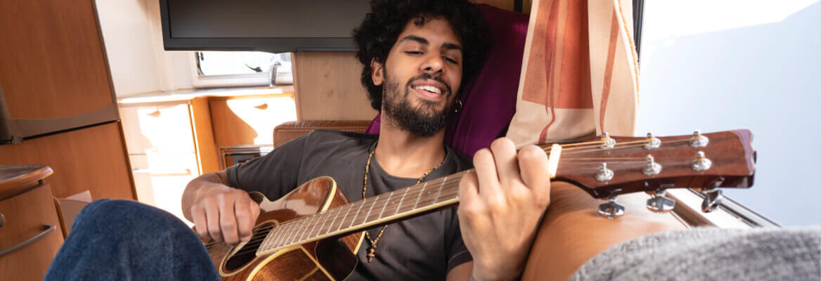 Man playing guitar in RV motorhome